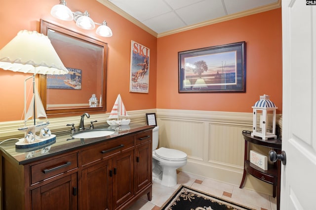 bathroom featuring vanity, toilet, ornamental molding, and tile patterned flooring