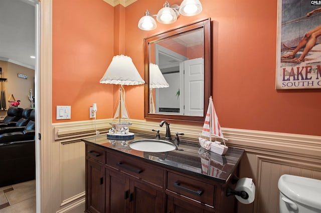 bathroom featuring toilet, ornamental molding, vanity, and tile patterned flooring