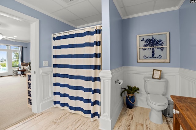 bathroom featuring toilet, ornamental molding, hardwood / wood-style floors, vanity, and ceiling fan