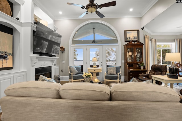 living room with french doors, ceiling fan, and crown molding