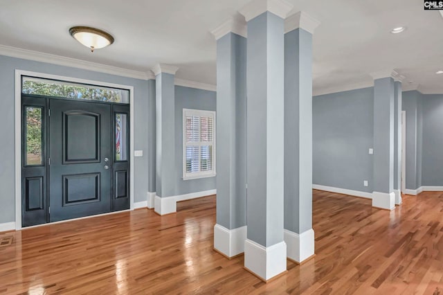 foyer entrance with hardwood / wood-style flooring and ornamental molding