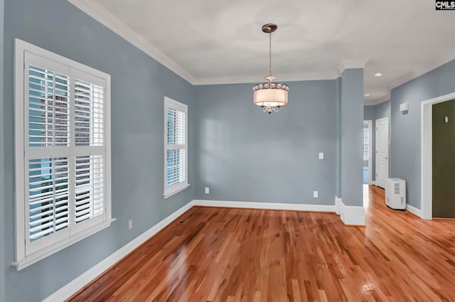 spare room featuring ornamental molding and wood-type flooring