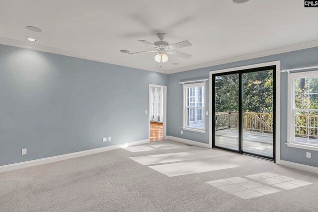 spare room with light carpet, crown molding, and ceiling fan