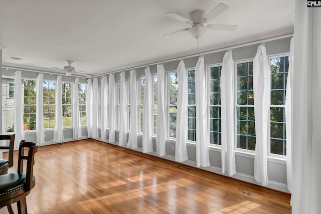 sunroom featuring plenty of natural light and ceiling fan