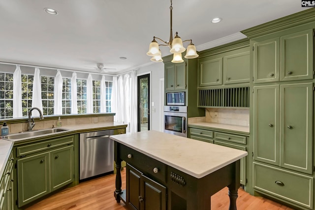 kitchen with crown molding, appliances with stainless steel finishes, sink, and light wood-type flooring