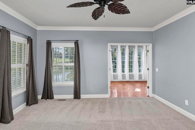 carpeted empty room with ornamental molding and ceiling fan