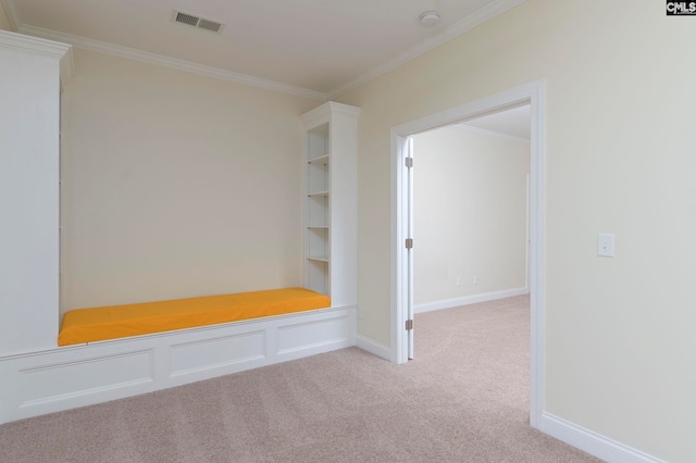 mudroom featuring crown molding and light colored carpet