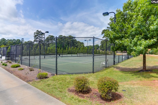 view of sport court featuring a lawn