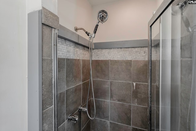 interior details featuring a shower with door