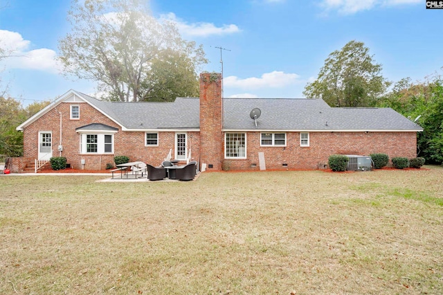 rear view of house with a patio, a yard, and central AC unit