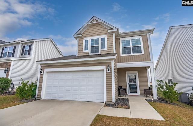 view of front of property with a garage and central AC