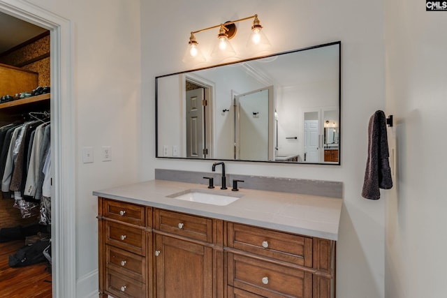 bathroom featuring crown molding and vanity