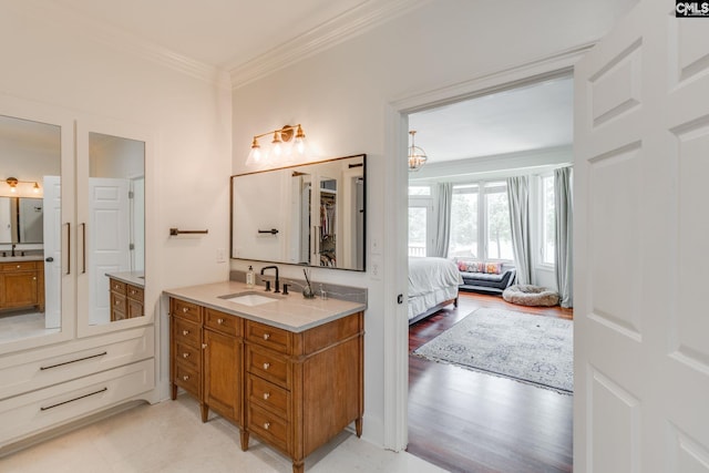 bathroom featuring vanity, hardwood / wood-style floors, and crown molding