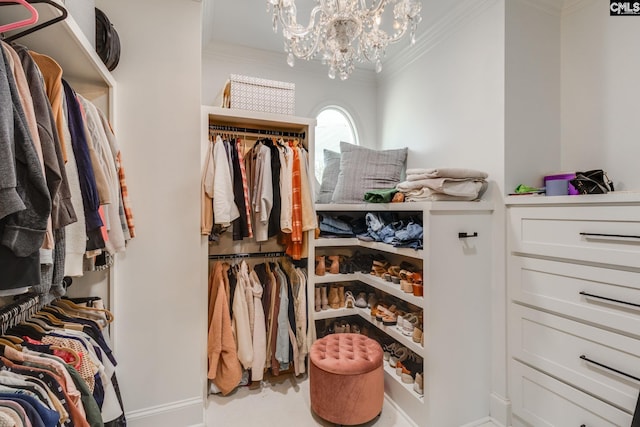 spacious closet with a chandelier