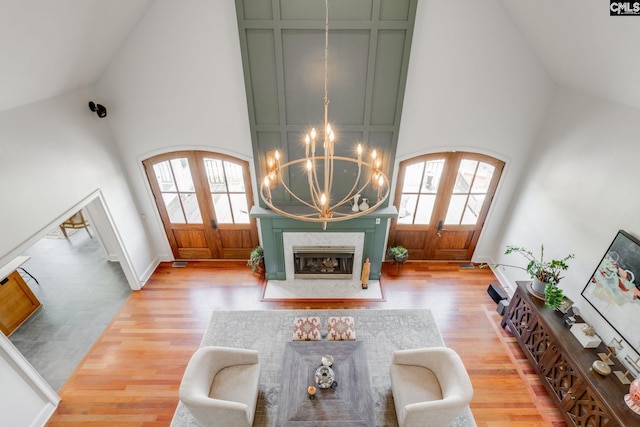 living room featuring french doors, a healthy amount of sunlight, and high vaulted ceiling