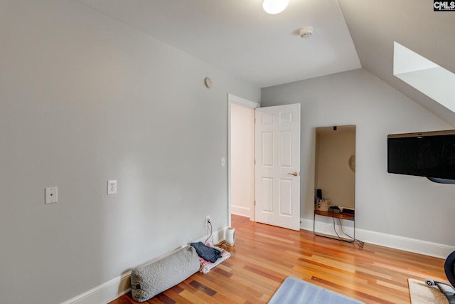 interior space with vaulted ceiling and hardwood / wood-style floors