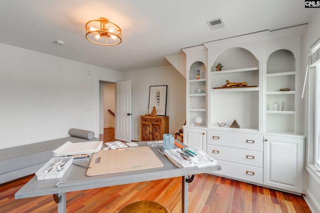 office area featuring light hardwood / wood-style flooring and a chandelier