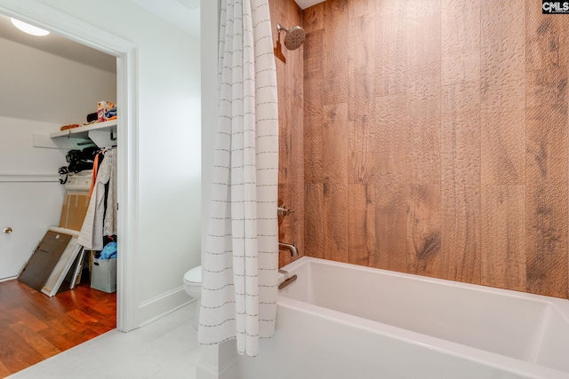 bathroom with toilet and shower / bath combo with shower curtain