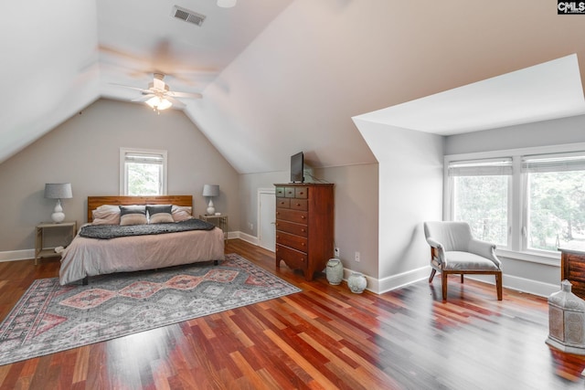 bedroom with ceiling fan, lofted ceiling, and wood-type flooring