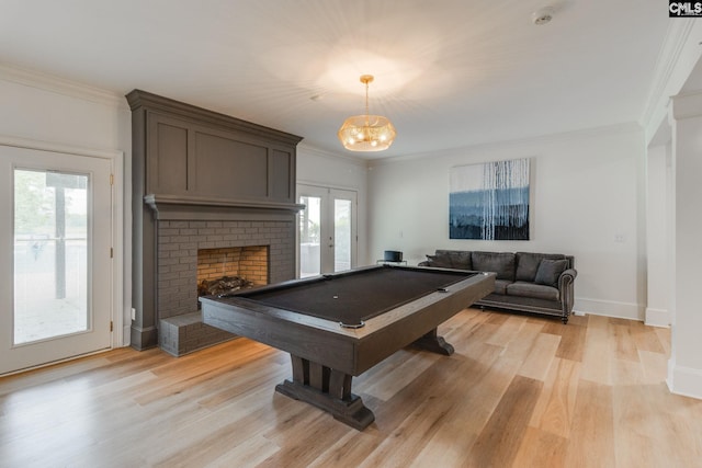 playroom with ornamental molding, billiards, a fireplace, and light hardwood / wood-style flooring