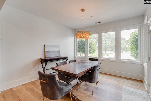 dining room with plenty of natural light and light hardwood / wood-style floors