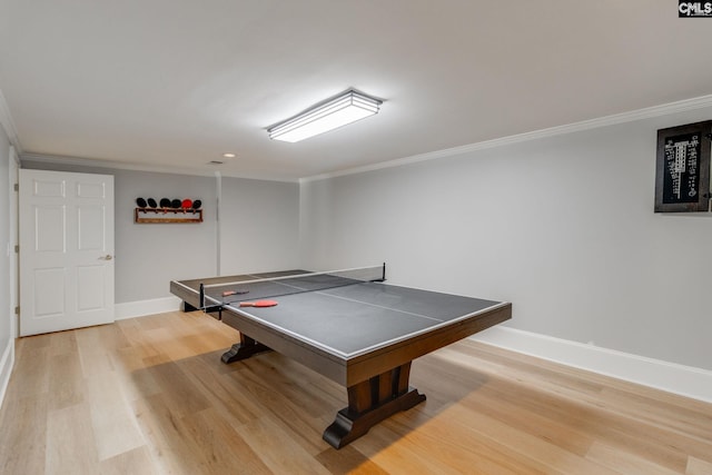 rec room with crown molding and light hardwood / wood-style floors