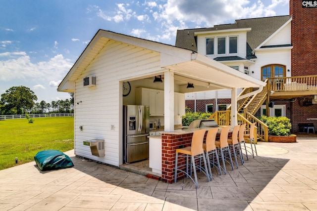 view of patio featuring exterior bar