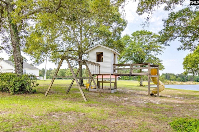 view of play area featuring a lawn and a water view