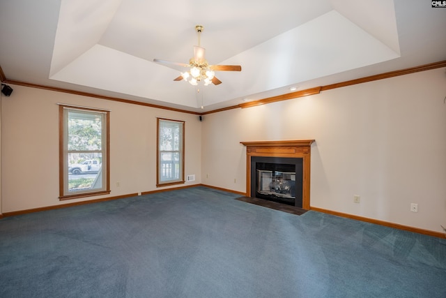 unfurnished living room with crown molding, a tray ceiling, and carpet