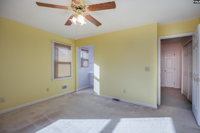 spare room with light carpet and ceiling fan