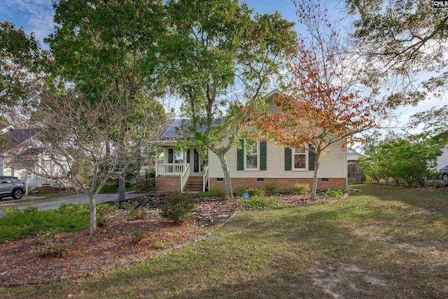 view of property hidden behind natural elements featuring a porch