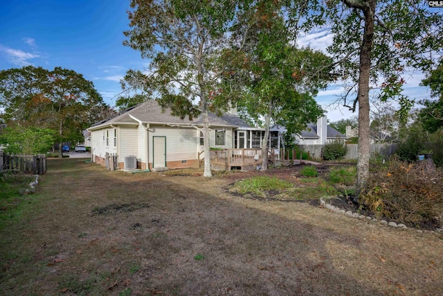 rear view of house with a wooden deck and cooling unit