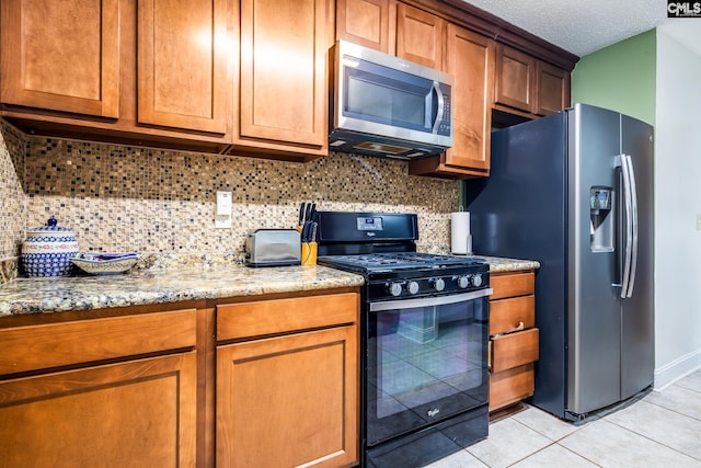 401 Nottingham Rd, Columbia, SC 29210 - kitchen featuring light stone counters, backsplash, light tile patterned floors, and stainless steel appliances