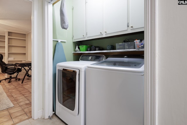 laundry room with light tile patterned flooring, independent washer and dryer, and cabinets