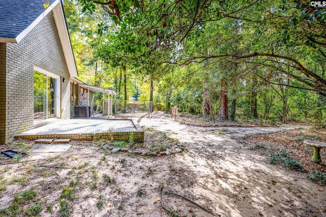 view of yard with a patio and central air condition unit