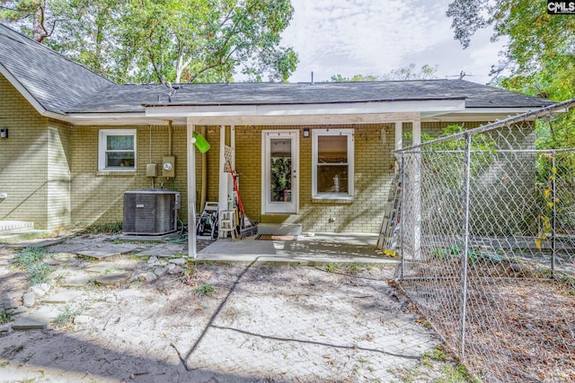 rear view of house with a patio area and central AC unit