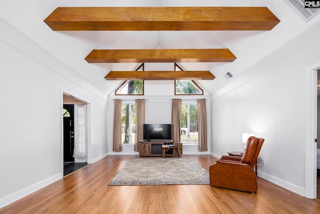 living room with hardwood / wood-style flooring and lofted ceiling with beams