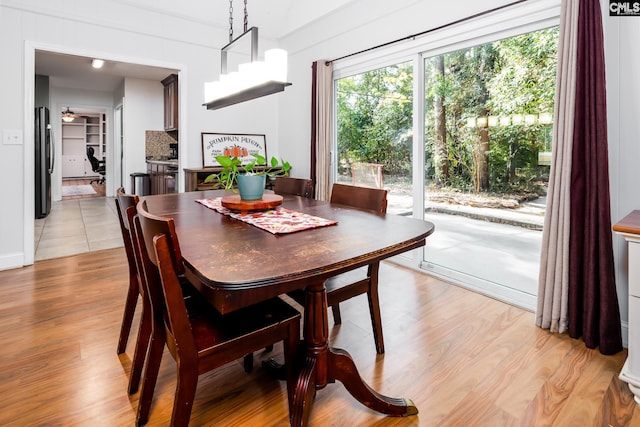 dining room with light hardwood / wood-style flooring and ceiling fan