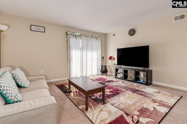 carpeted living room featuring a textured ceiling