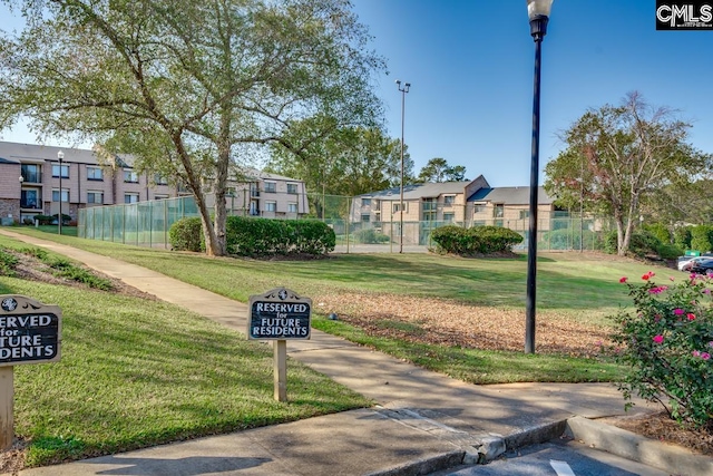 view of home's community with a lawn