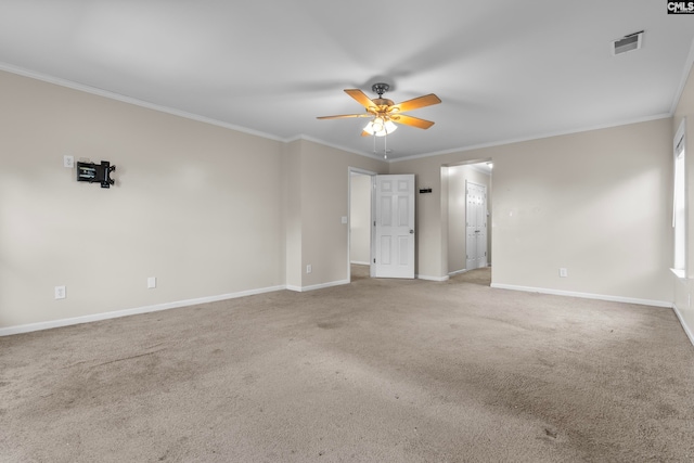 spare room with crown molding, carpet flooring, and ceiling fan