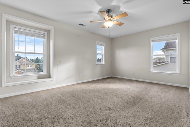 carpeted spare room with ceiling fan