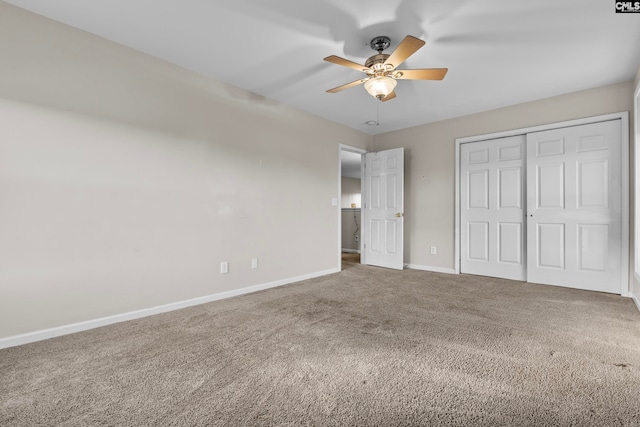 unfurnished bedroom featuring carpet floors, a closet, and ceiling fan