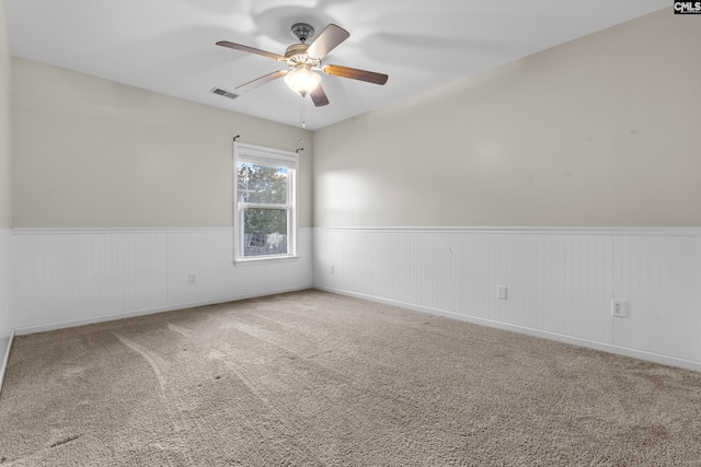 unfurnished room featuring ceiling fan and carpet floors