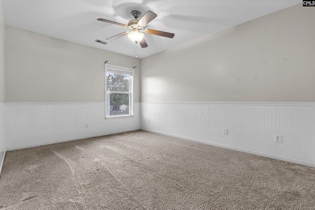 420 Indigo Ridge Dr, Columbia, SC 29229 - carpeted spare room with visible vents, a ceiling fan, and a wainscoted wall