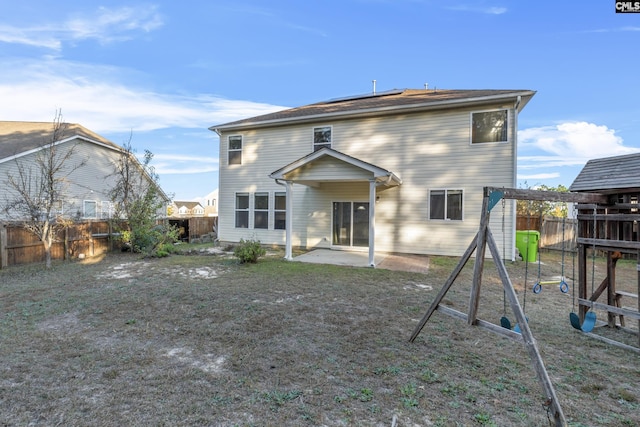 420 Indigo Ridge Dr, Columbia, SC 29229 - rear view of house featuring a fenced backyard, roof mounted solar panels, a playground, and a patio area