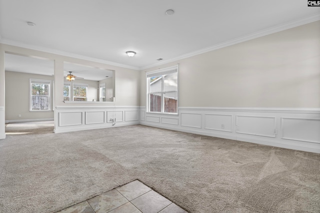 unfurnished living room with ornamental molding, light colored carpet, and ceiling fan