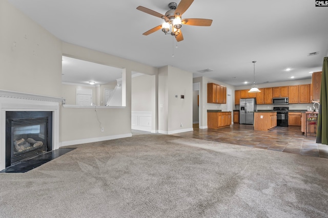 unfurnished living room featuring ceiling fan, sink, and dark carpet