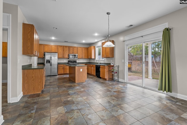 420 Indigo Ridge Dr, Columbia, SC 29229 - kitchen with baseboards, brown cabinetry, appliances with stainless steel finishes, and dark countertops