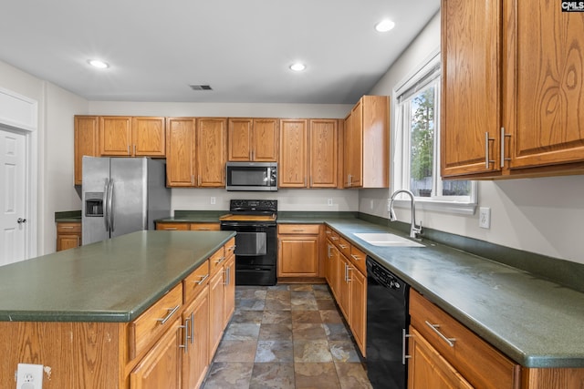 420 Indigo Ridge Dr, Columbia, SC 29229 - kitchen featuring brown cabinetry, dark countertops, stone finish floor, a sink, and black appliances